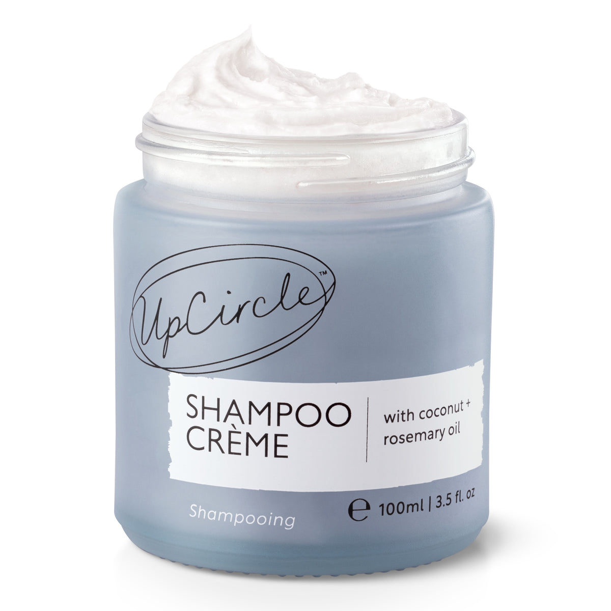 Blue jar of UpCircle Shampoo Crème with Coconut and Rosemary Oil. The shampoo Crème is whipped out the top of the jar, on a white background.