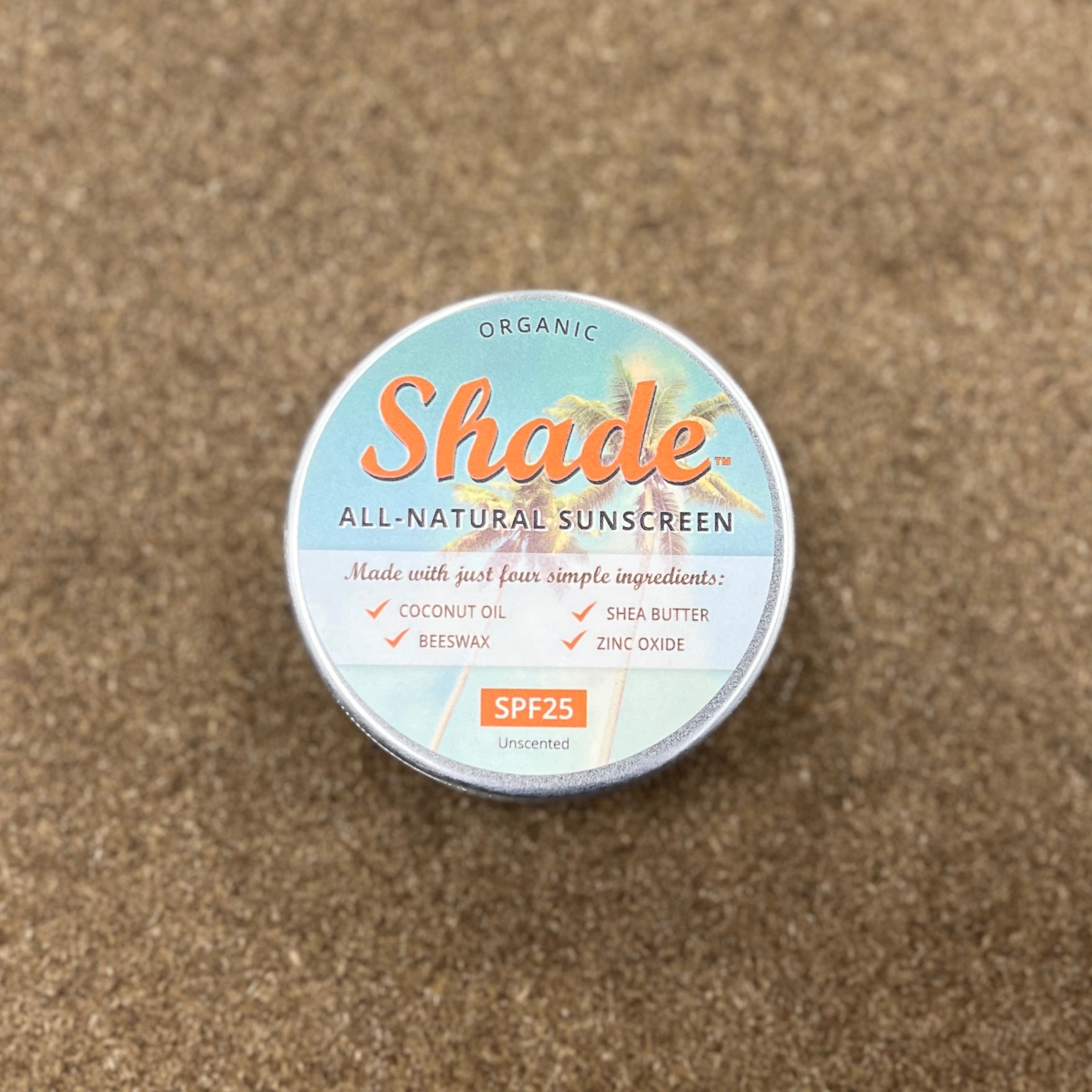 Tin sat on wooden background, with writing detailing the contents