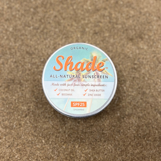 Tin sat on wooden background, with writing detailing the contents