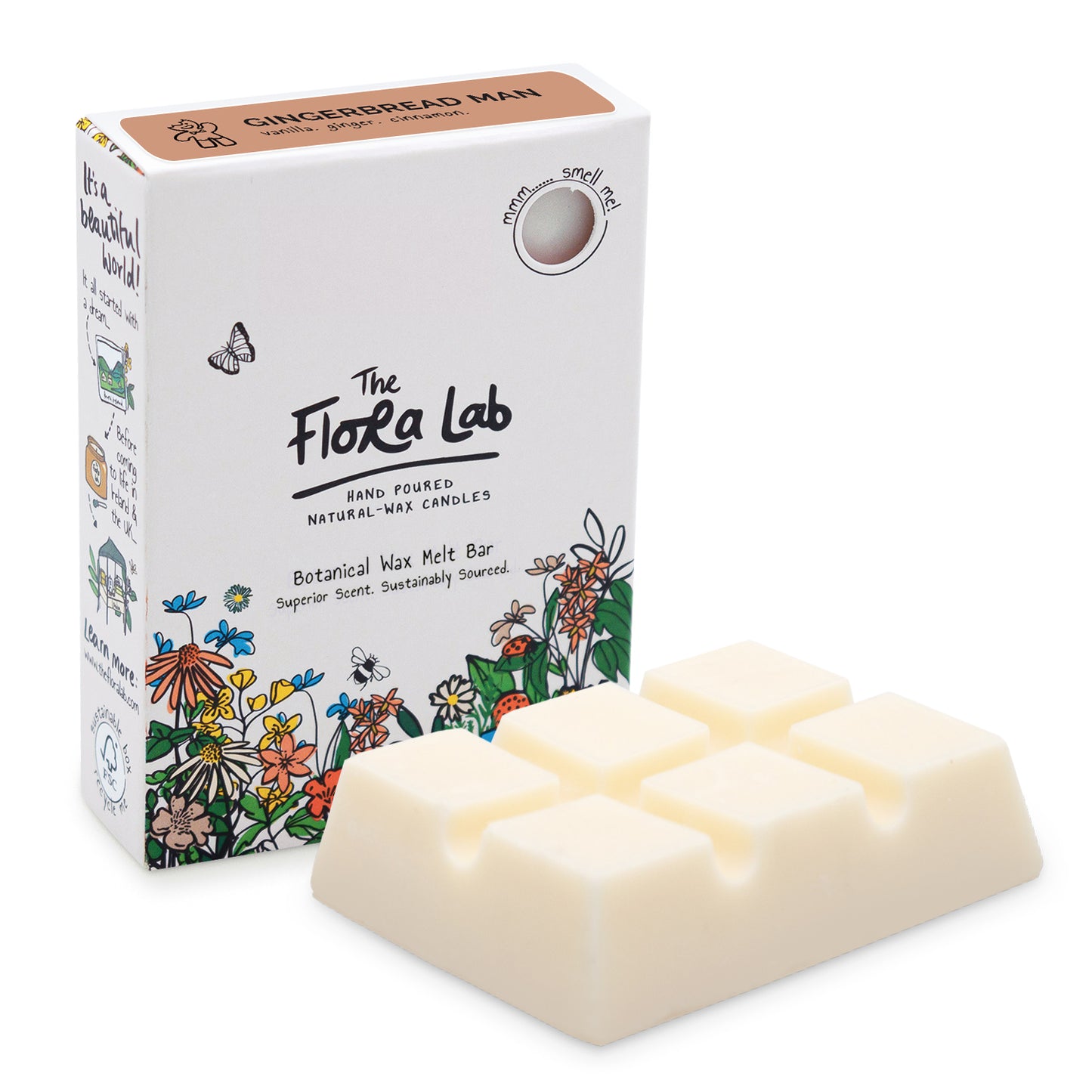 The Flora Lab Gingerbread Man Scented Wax Melts. A slab of white wax melts, unboxed in the foreground, with the white box (with floral decoration around the bottom) stood on end slightly behind and to the left.